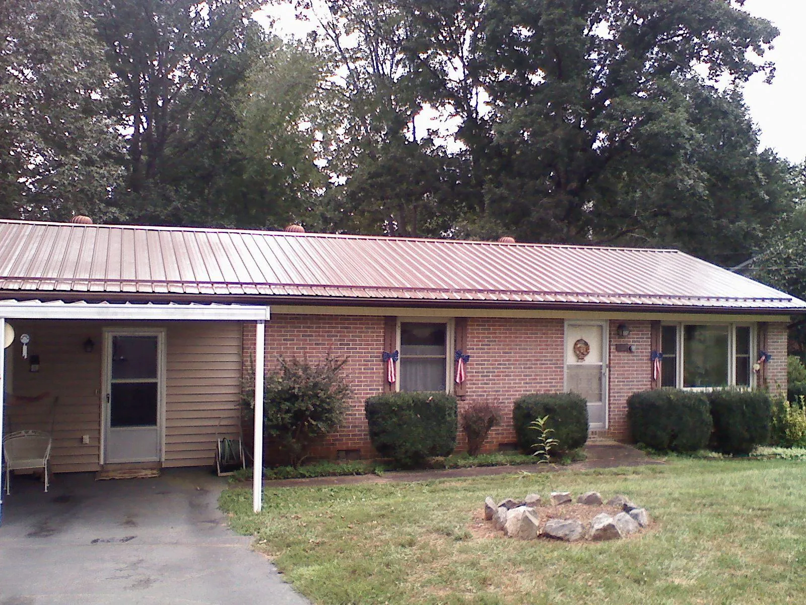 Bronze metal roof and carport on a brick ranch home — Roof Repair work by our crew in Fingal