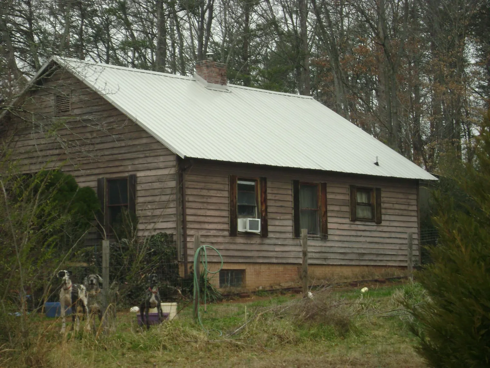 White metal roof on an old wood sided farmhouse, from a Metal Roof Installation job in Fingal